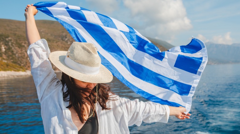 woman holding a Greek flag 