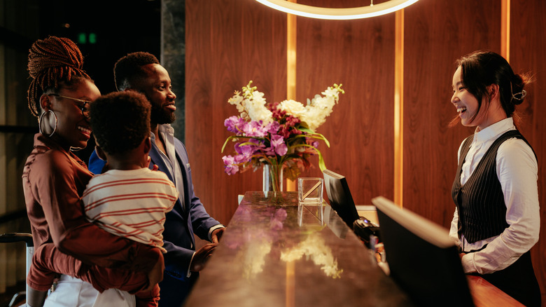 A family checking into a hotel