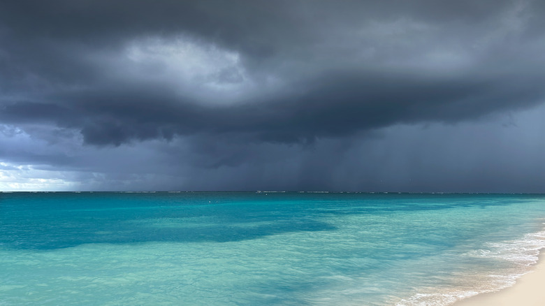 hurricane brewing over caribbean sea and white beach