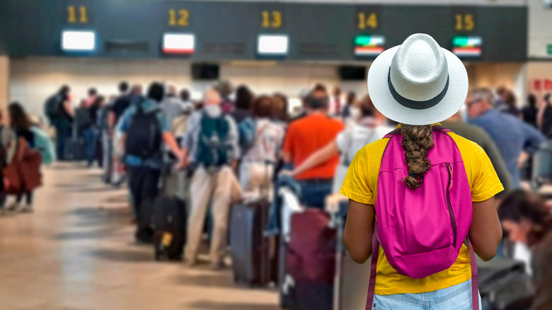 Tourist looking at long airport line