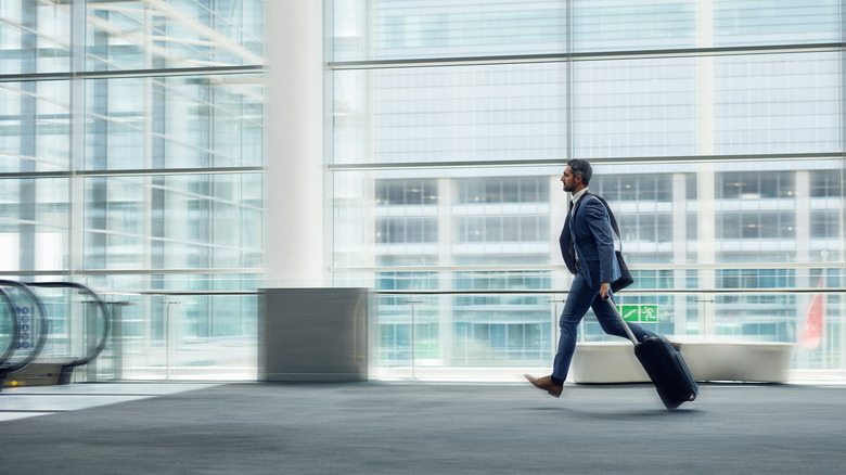 man running through airport 