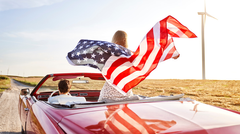 couple's car flying American flag