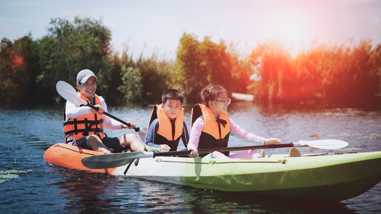 Family kayaking on the lake