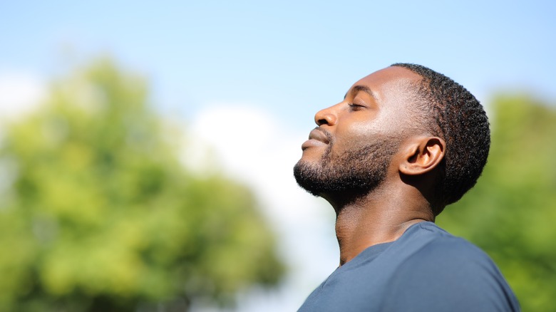 Man taking a deep breath