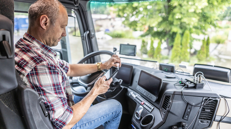 RV driver checking cellphone