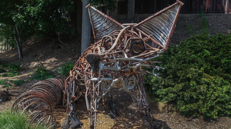 Street art piece depicting a fox made of old bicycles