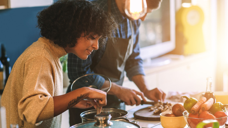 two people cooking in kitchen