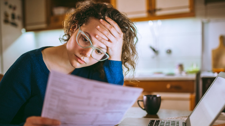 sad woman reading credit statement
