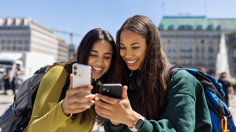 travelers look at their cell phones