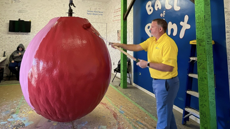 Man painting world's largest ball of paint
