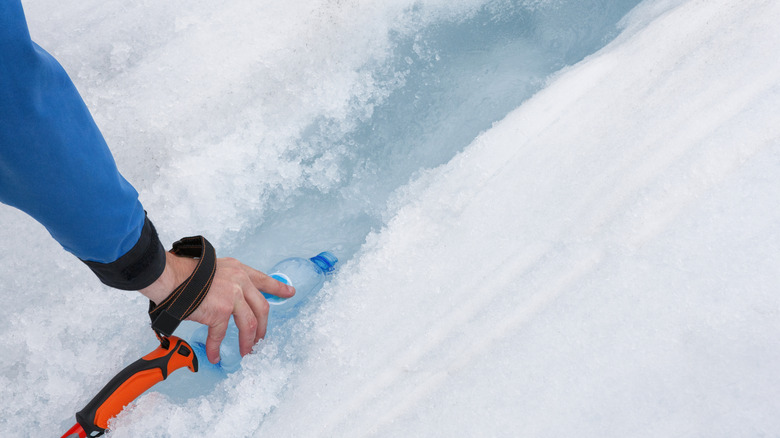 Filling bottle from glacier