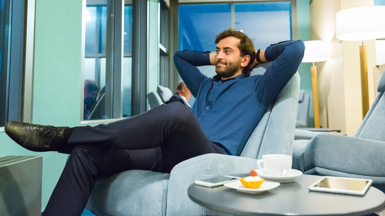 man reclining in airport lounge chair