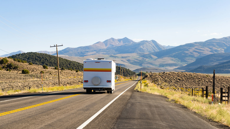 RV driving on California highway with mountains in distance