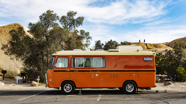 Retro orange RV parked with California mountain backdrop