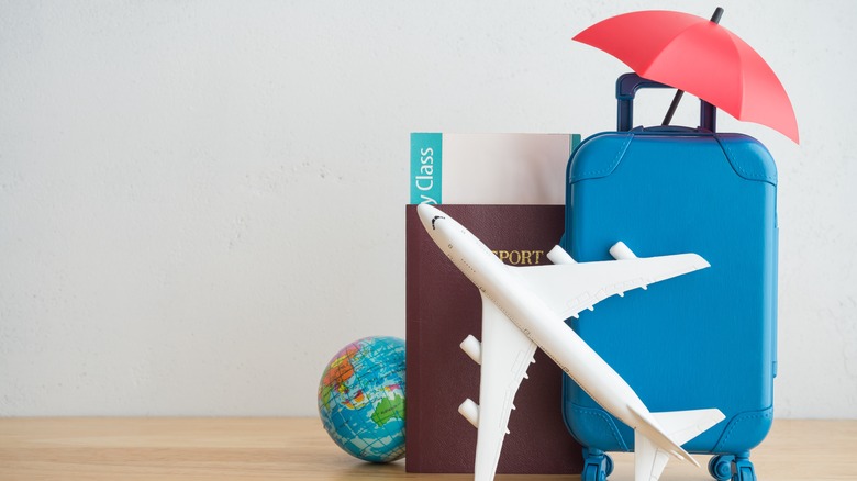 umbrella over suitcase and passport