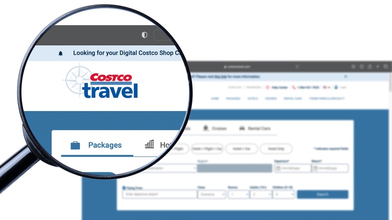 Magnifying glass up against Costco Travel website on computer screen
