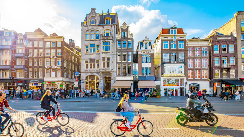 People riding bikes through a town in the Netherlands