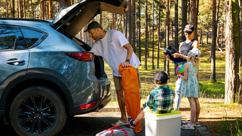 A family packing their car for a camping trip