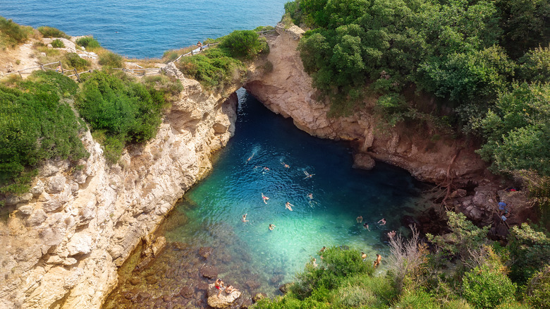 people swim in Italian pool Bagni Regina Giovanna on Capo di Sorrento
