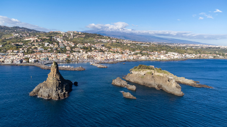 Rocky volcanic islands in the sea off the coast of the town of Acireale