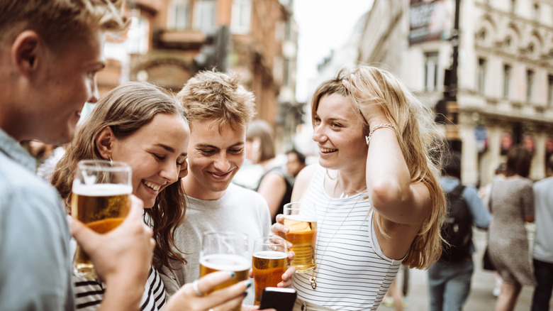 friends laughing and drinking outside