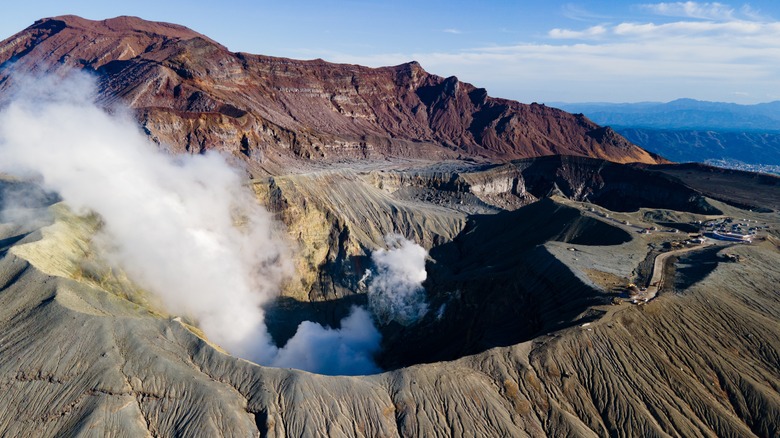 the crater of Nakadake at Mount Aso with steam rising