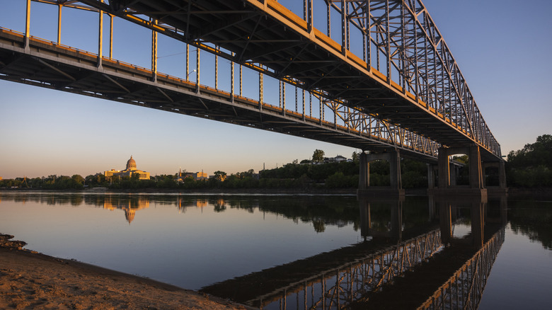 a bridge crosses over the Missouri River with the domed Missouri State Capitol in Jefferson City on the other side