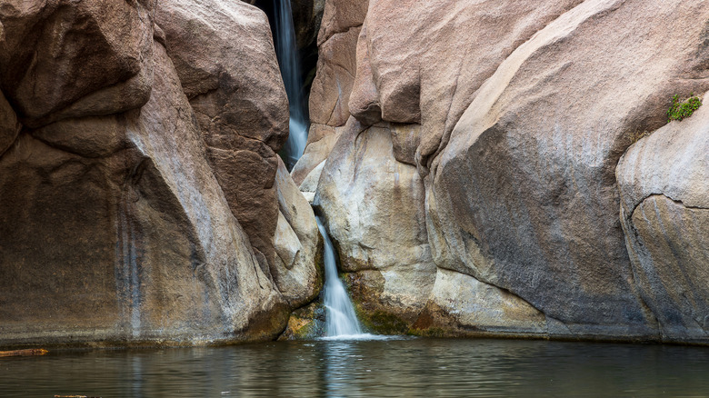View of waterfall cascading between rock faces at Guffey Gorge in Colorado