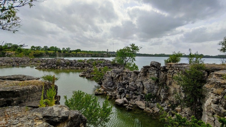 Limestone cliffs next to a lake in Lehigh Portland State Park in Kansas.