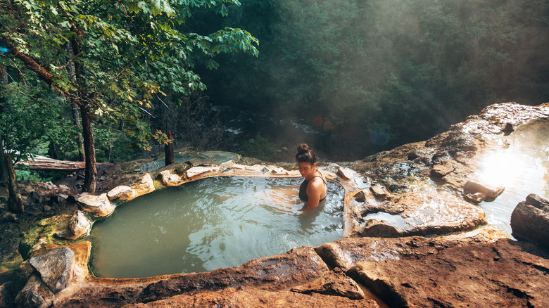 Woman in hot spring in forest