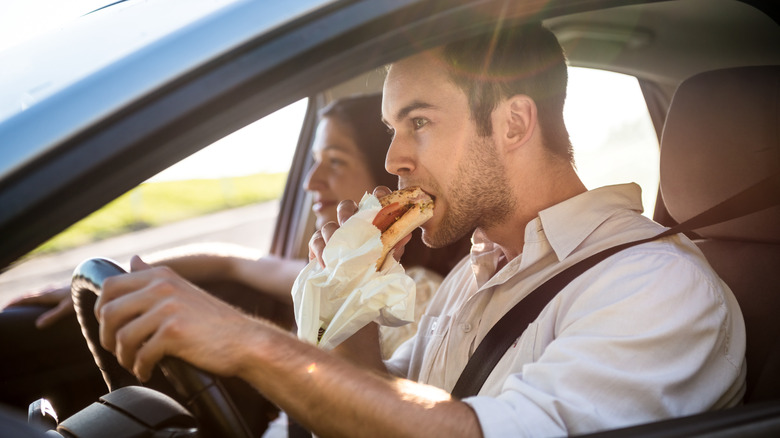 people eating in a car