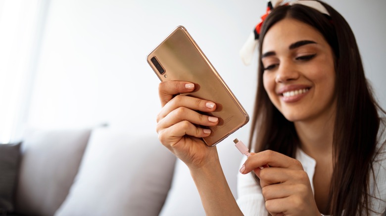 Woman plugs in phone