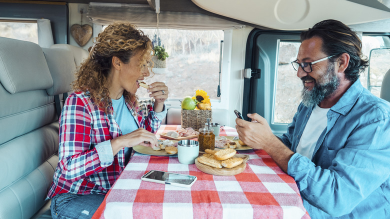couple eating meal on RV
