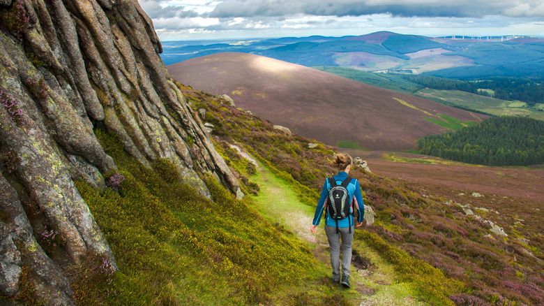 A woman hiking through Cairngorms National Park in Scotland.