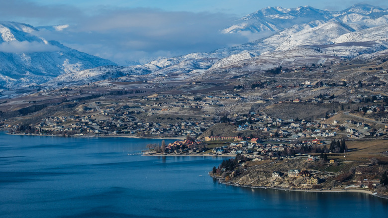 An aerial view of Lake Chelan and the surrounding mountains and town in winter