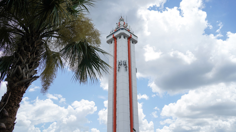 Orange-and-white tower with palm tree