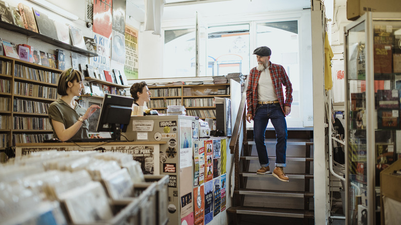 Man greets staff at a record store