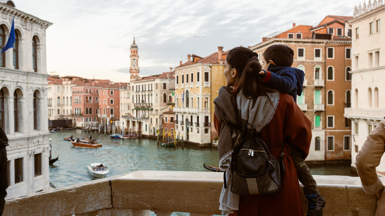 Mom and child on Venice bridge