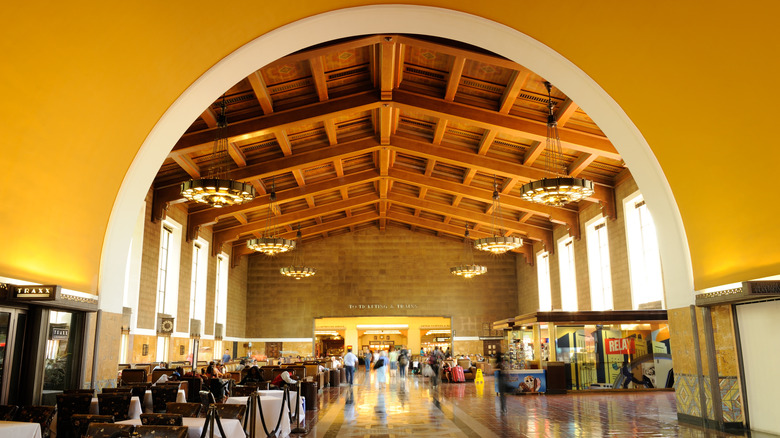 The warm-toned interior of Union Station, the busiest train station in Los Angeles, California