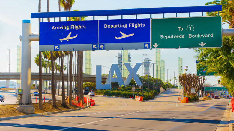 Signage indicating flight arrivals and departures, and Sepulveda Boulevard