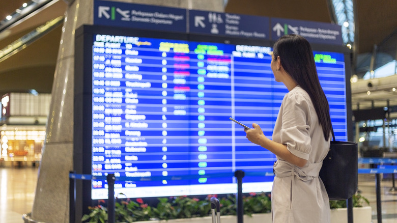 Woman looking at airport screen