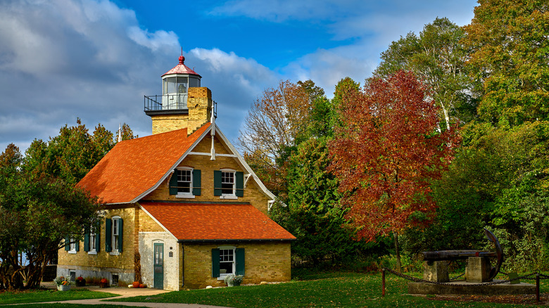 The light-brick Eagle Bluff Lighthouse tucked amongst the trees