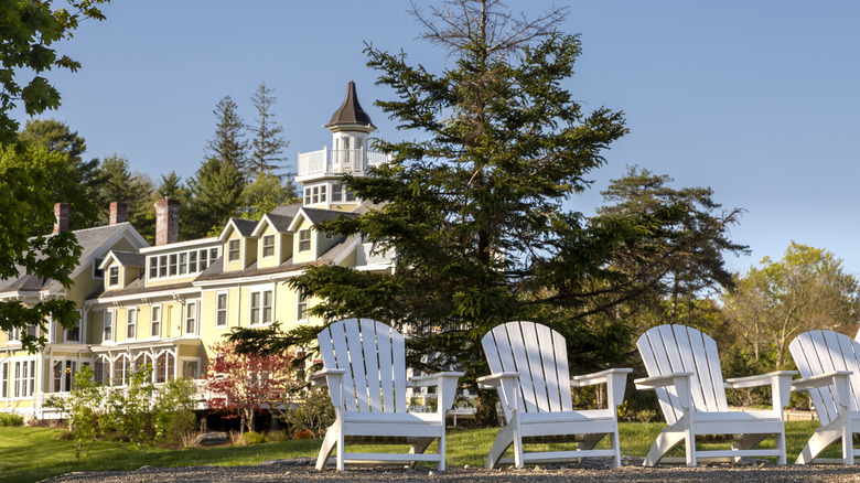 White Adirondack chairs sit outside kitschy old inn in Belfast