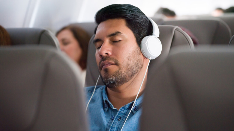 Man sleeping on plane