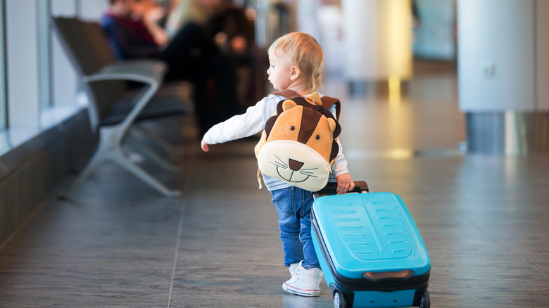 toddler pulling his suitcase 