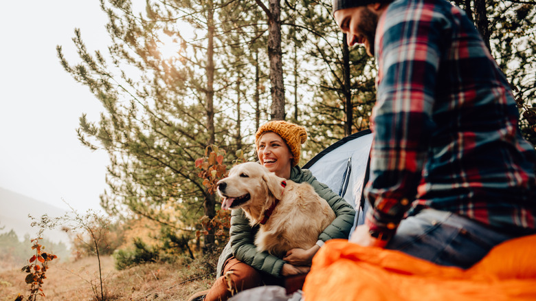 Couple camping with their pet