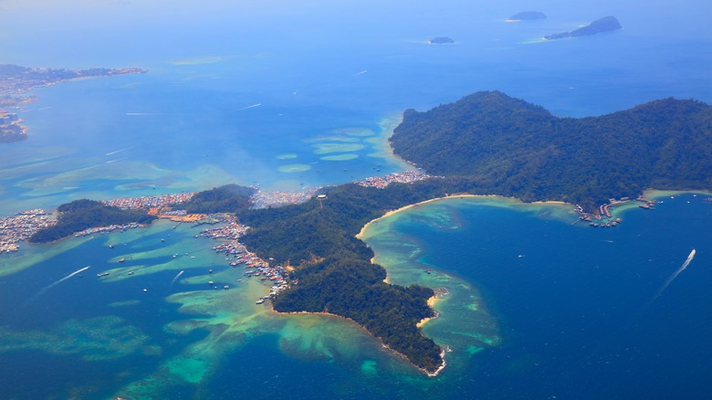 An aerial view of Gaya Island (Pulau Gaya) with coral reefs in Tunku Abdul Rahman National Park near Kota Kinabalu, Malaysia.