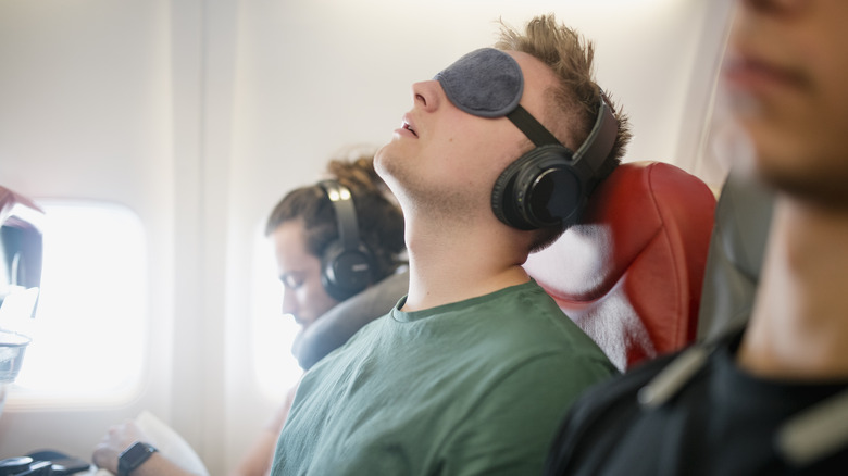 man sleeping on plane
