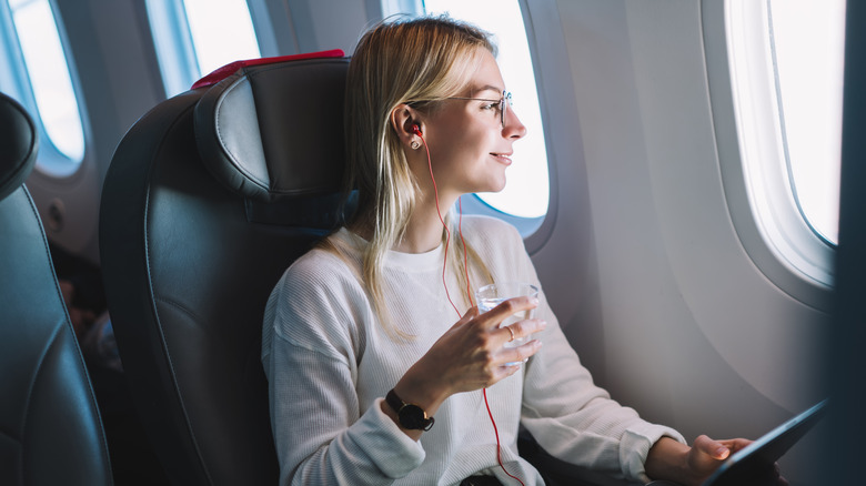 smiling woman on plane