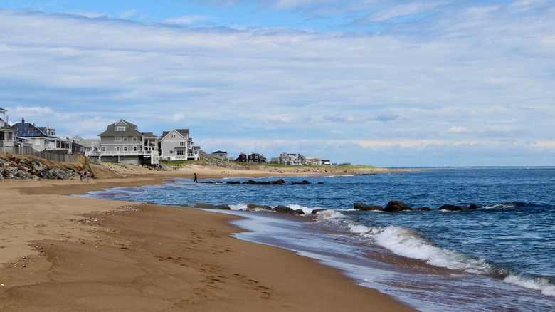 The shoreline at Plum Island Newburyport with wooden buildings in the background